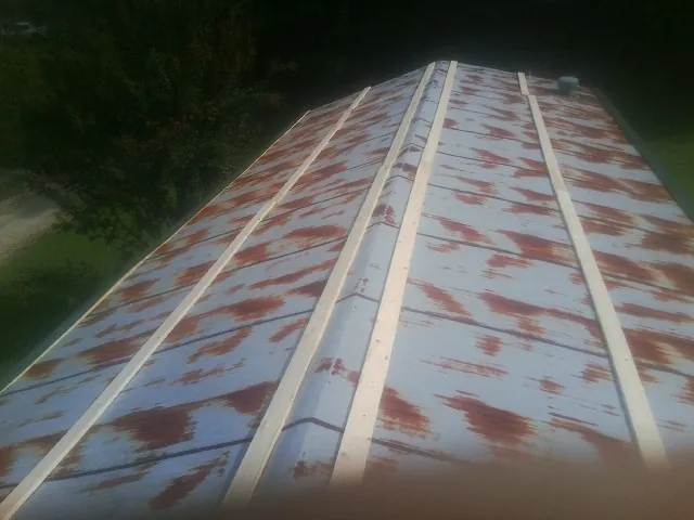 Rusted metal roof panels with new wood purlins before replacement — Storm Damage Roof Repair in Live Oak by Roofing Brothers