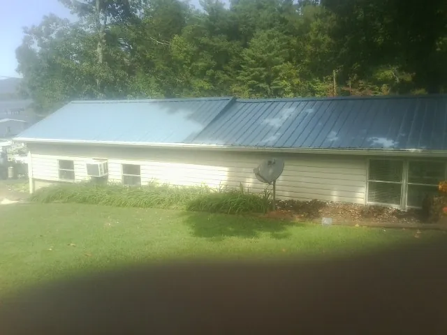 Blue metal roof running the length of a single story home in Live Oak